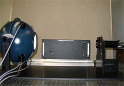 An integrating sphere (left) is used to calibrate the optic element (right). The spectrometer itself is in the middle of the photo. ARM file photo.