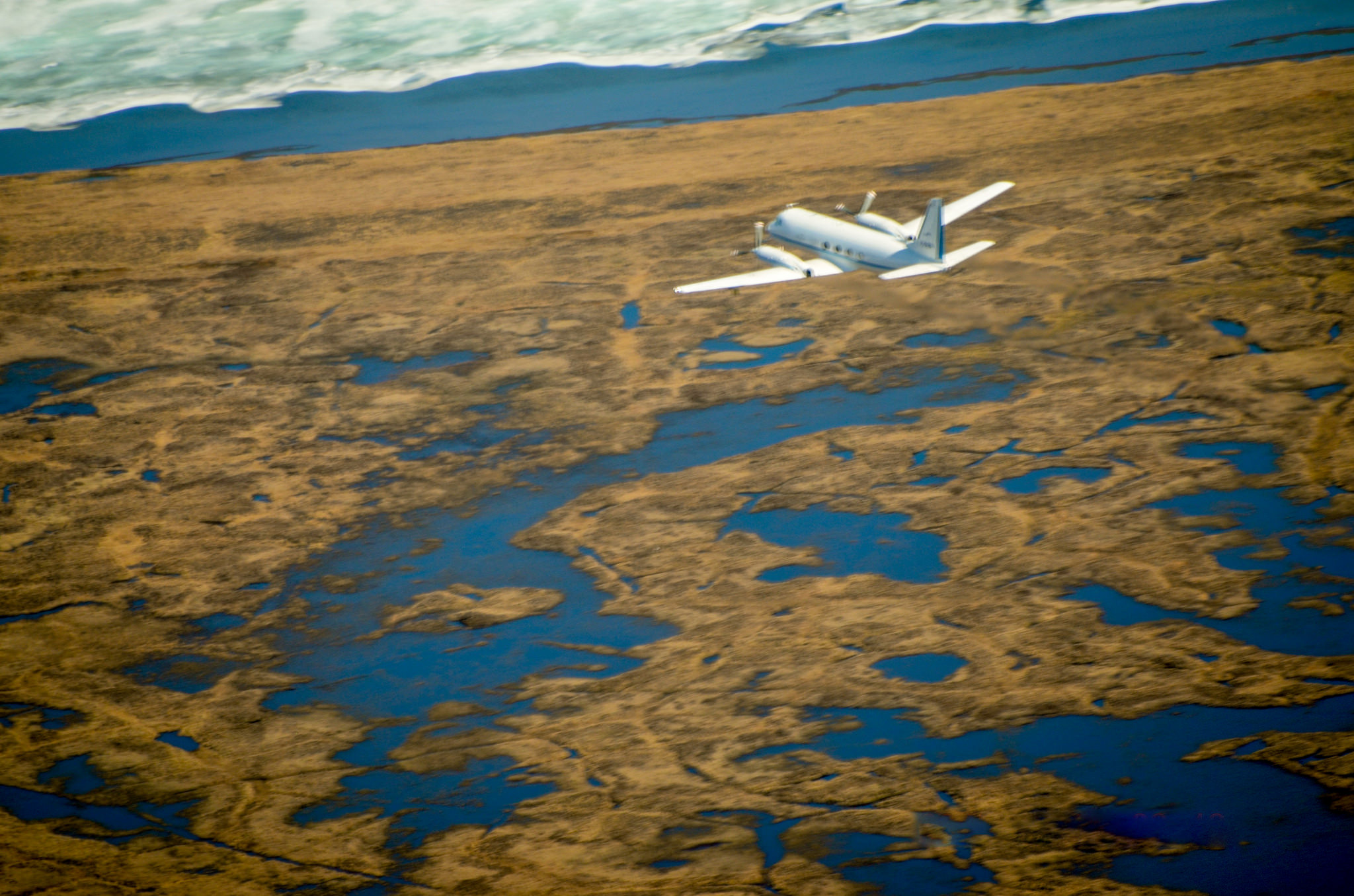 The Gulfstream-159 (G-1) research aircraft heads north towards Barrow, Alaska, in the summer of 2015, measuring trace gases above the treeless tundra and icy lakes of the Arctic.